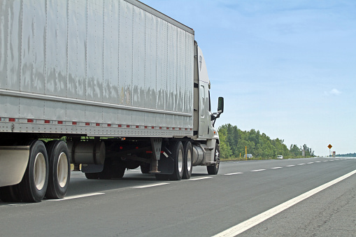 a tractor-trailer on a Massachusetts highway. The semi-truck does not have side underride guards.