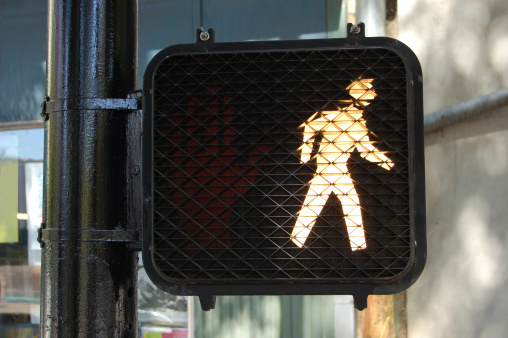 pedestrian crossing sign signaling it's safe to cross.