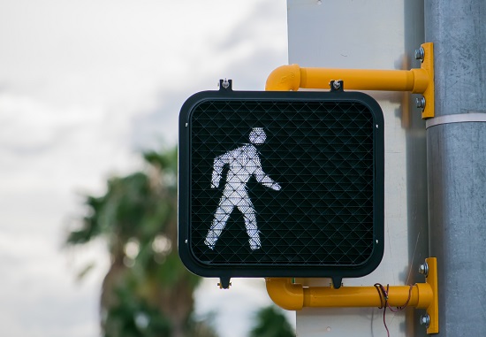 A pedestrian crossing signal indicating it's safe for people to use the crosswalk.